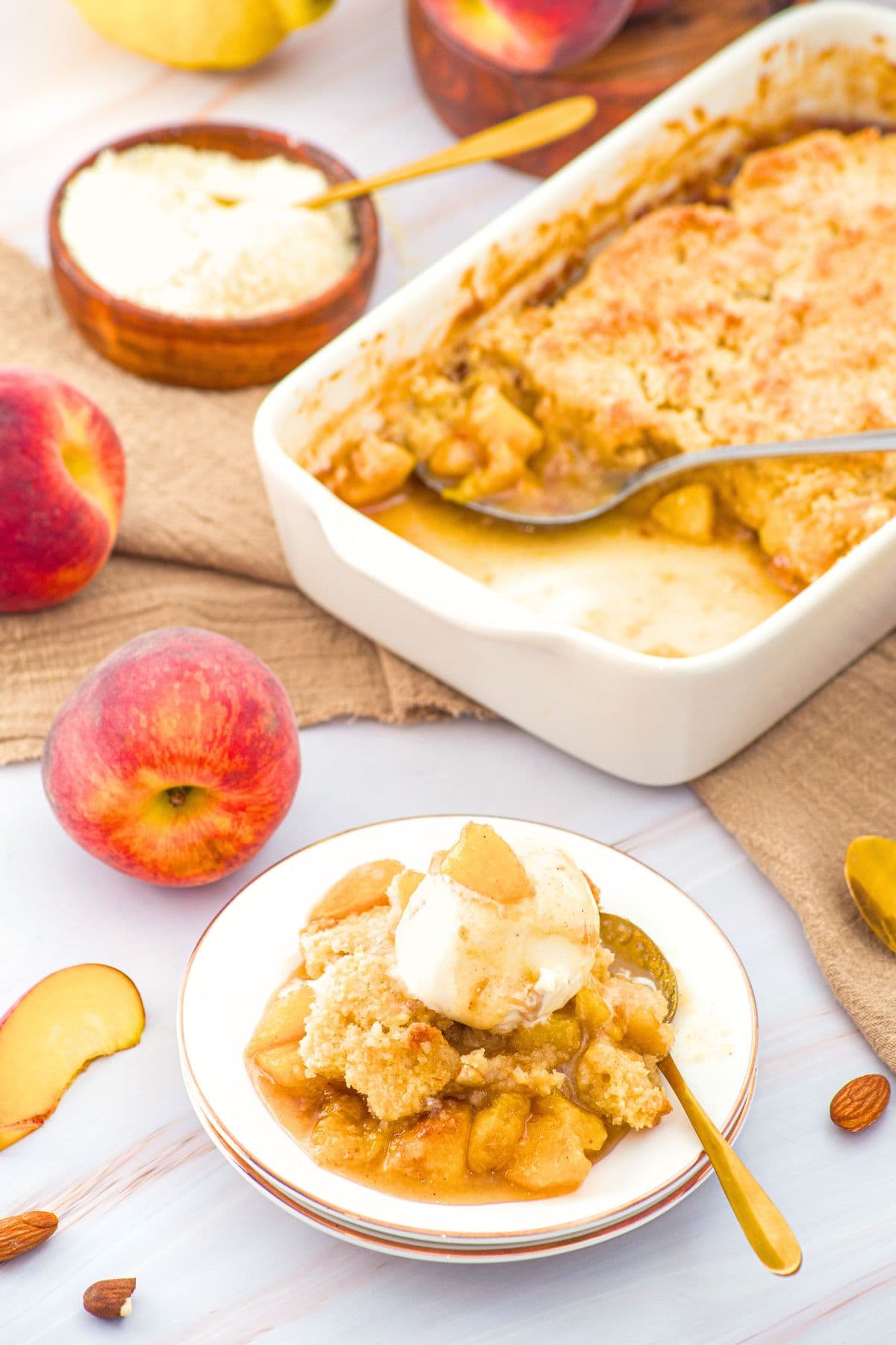 Baked Peach Dessert A plate of dairy-free peach cobbler with ice cream.