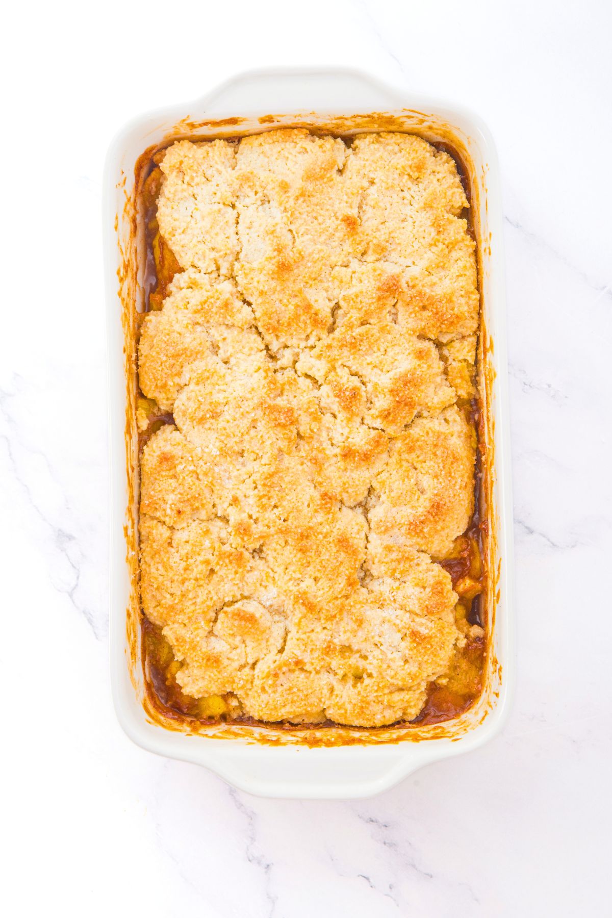 Healthy Peach Cobbler with Almond Flour Freshly baked almond flour peach cobbler in baking dish