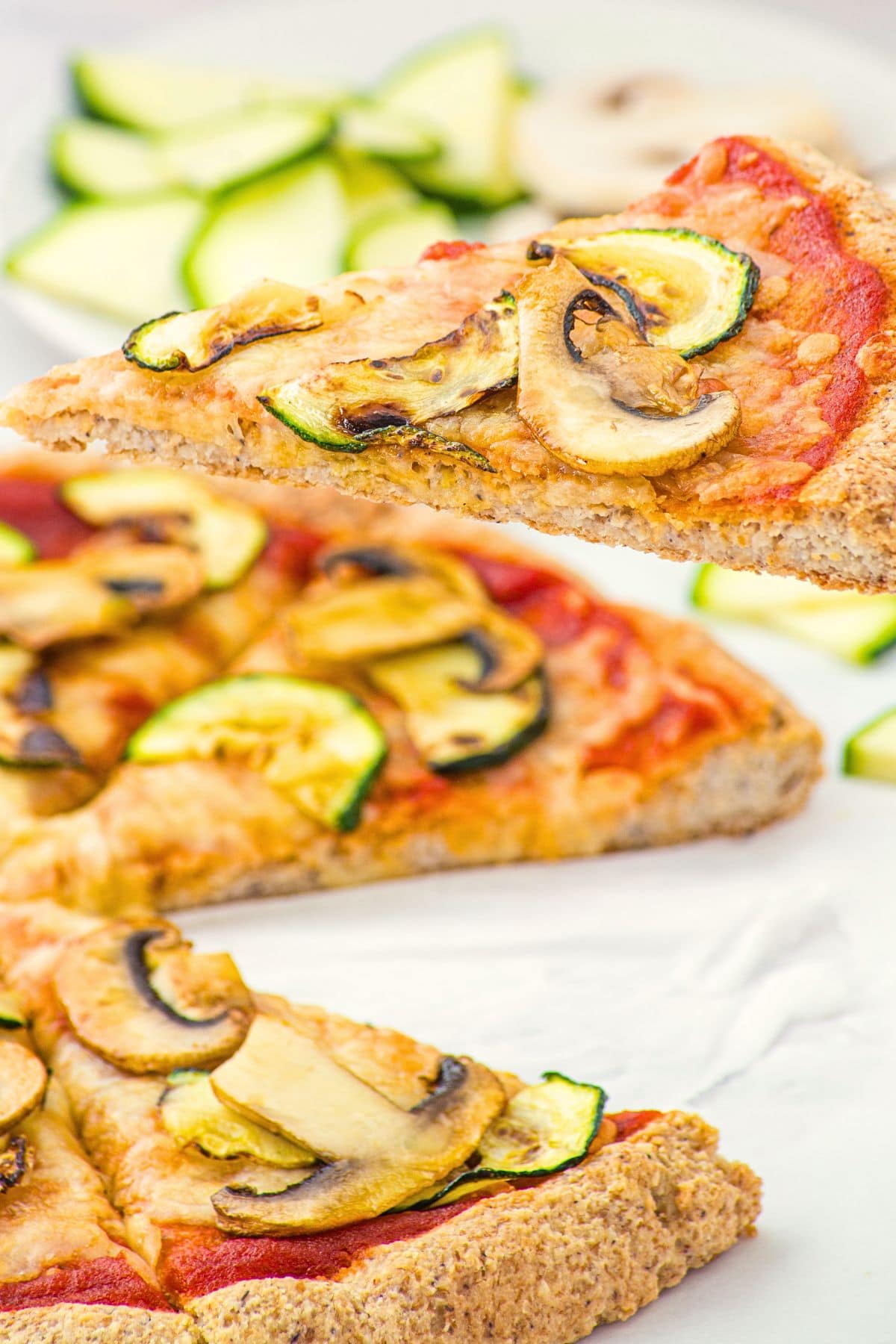 Holding up a slice of pizza