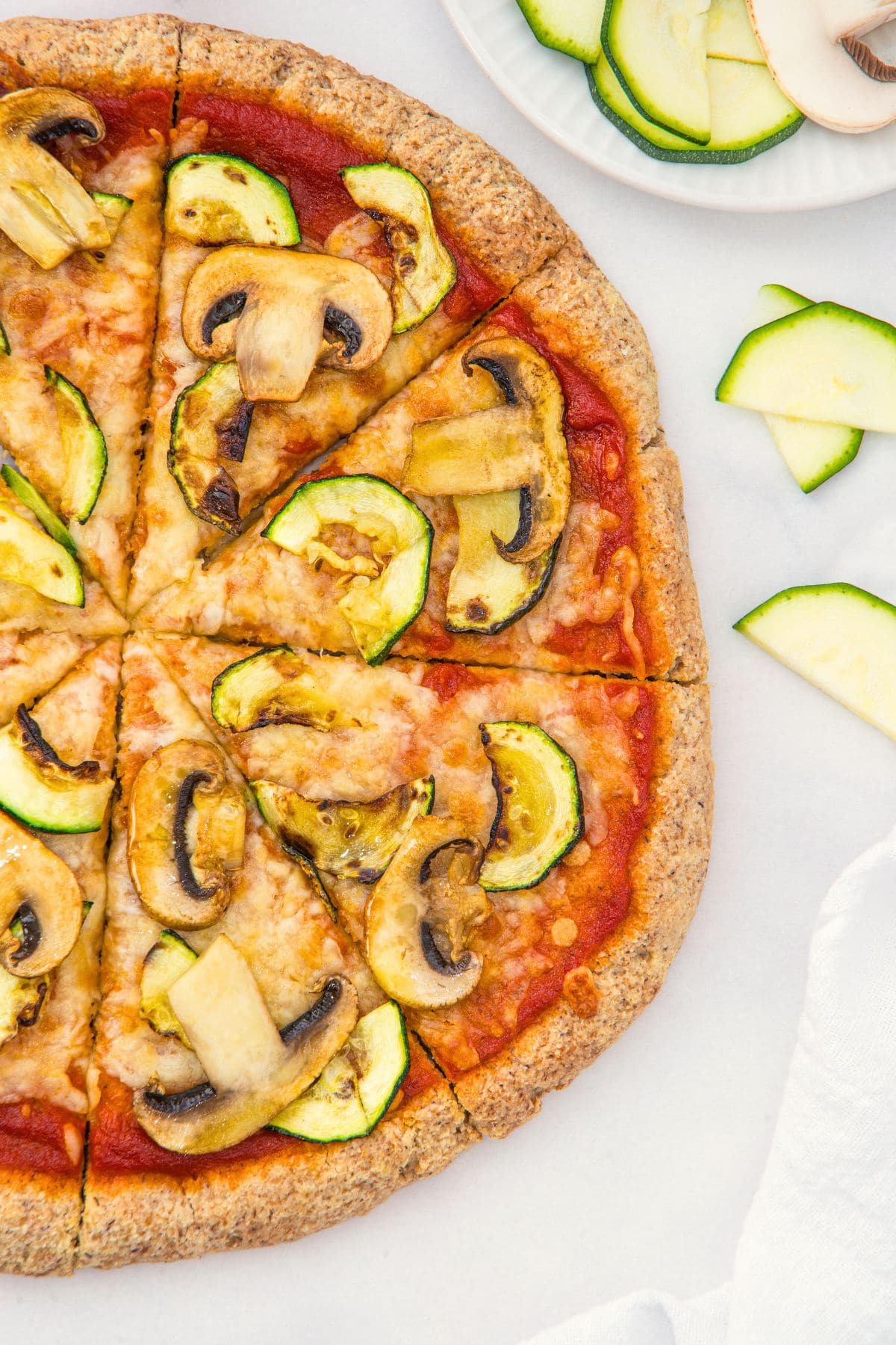 Up close view of pizza with mushrooms and zucchini