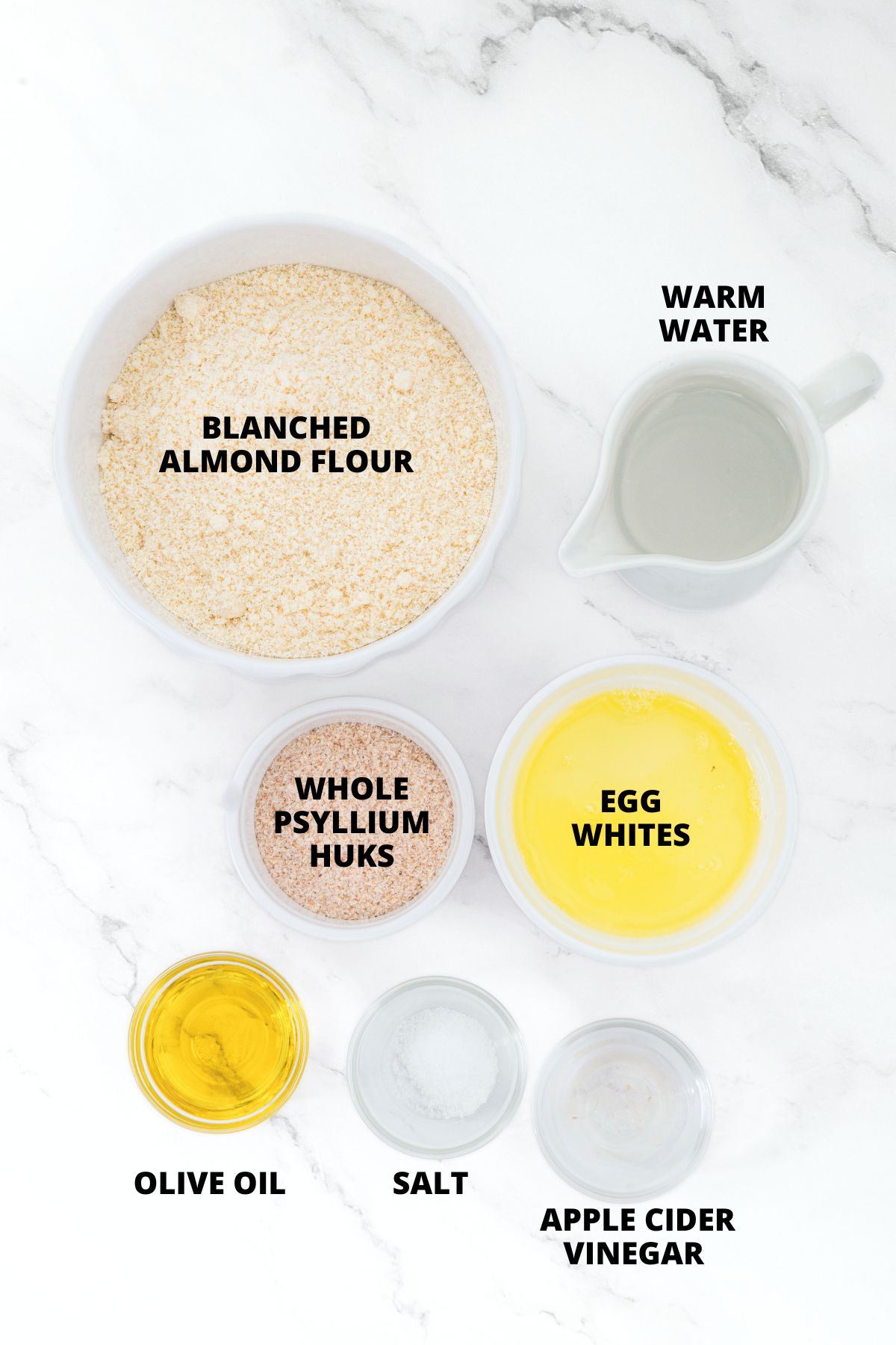 Ingredients for almond flour pizza crust laid out on marble board
