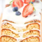Sliced loaf of gluten-free almond flour pound cake on wooden board