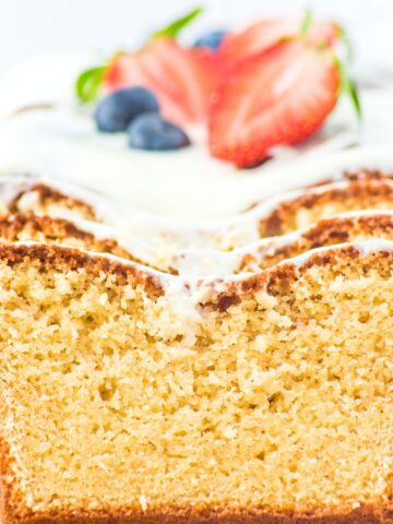 Up close view of the texture of half-sliced loaf of almond flour pound cake.