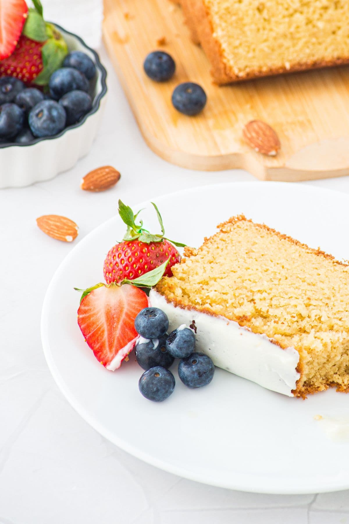 A plate of pound cake with almond flour and berries