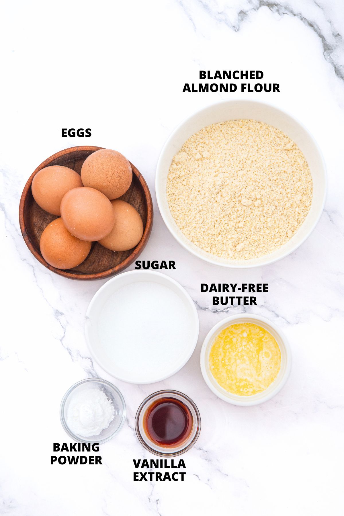 Ingredients for almond flour pound cake recipe laid out on marble board.
