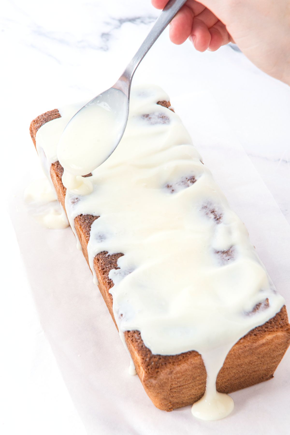 Spreading glaze over almond flour loaf cake