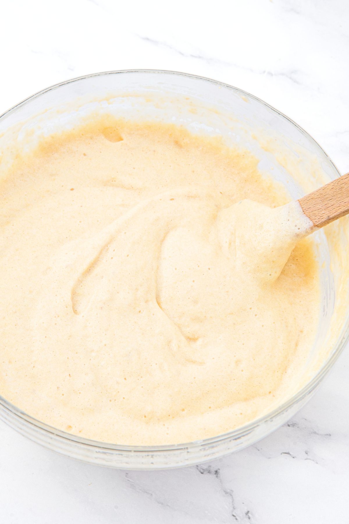 Stirring cake batter with wooden spatula