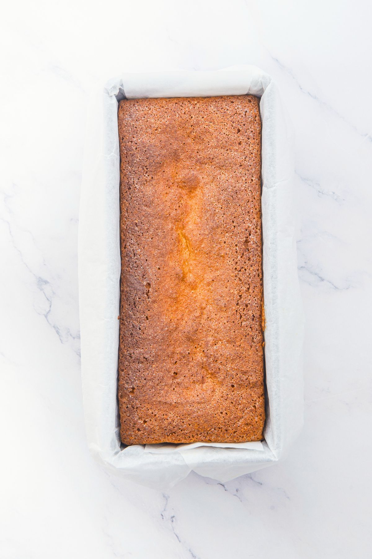 Freshly baked almond pound cake in loaf pan