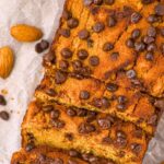Top down view of a sliced loaf of almond flour pumpkin bread with chocolate chips