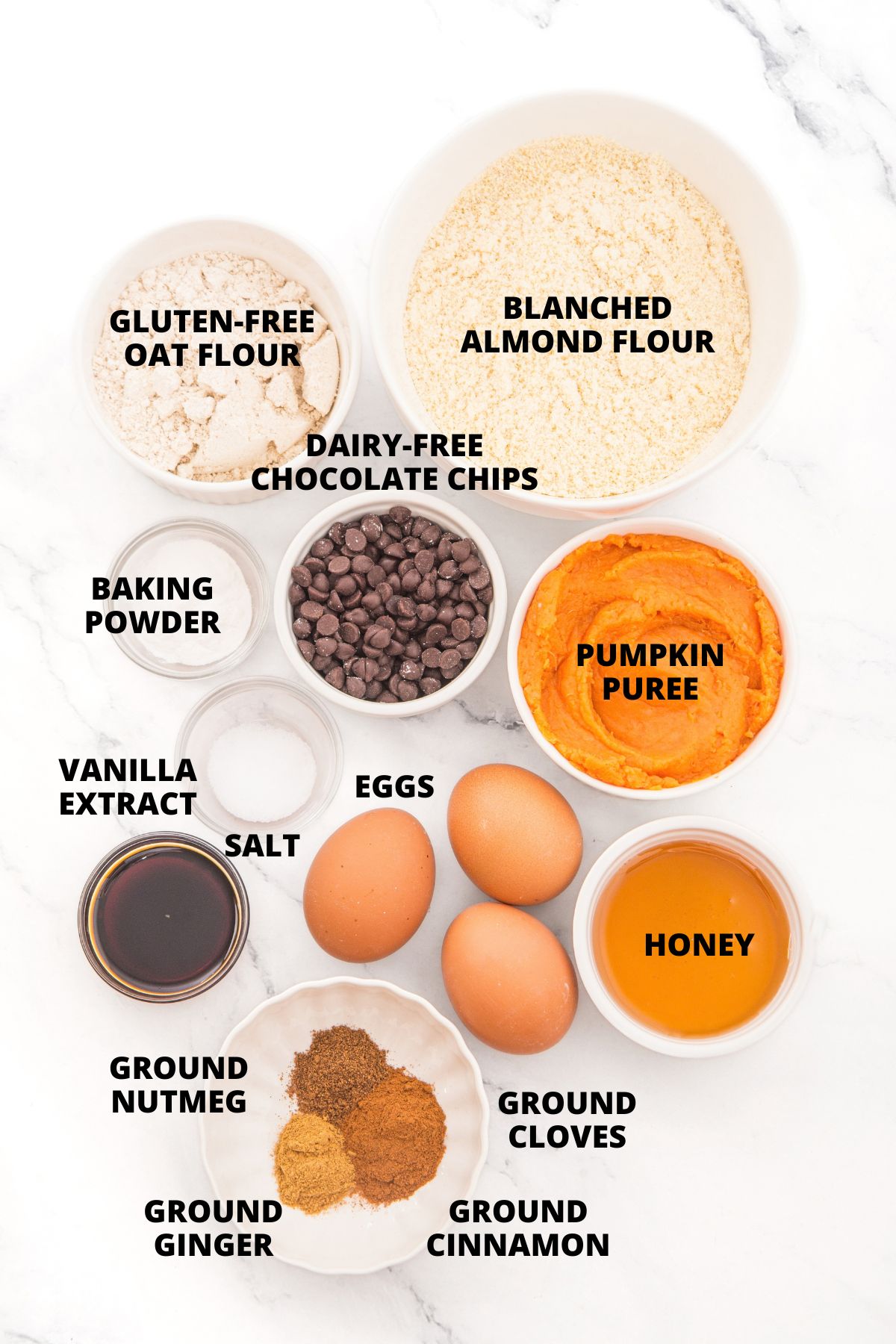 Almond Flour Pumpkin Bread Recipe (Gluten-Free, Dairy-Free) Top down view of ingredients for almond flour pumpkin bread recipe laid out on marble board.