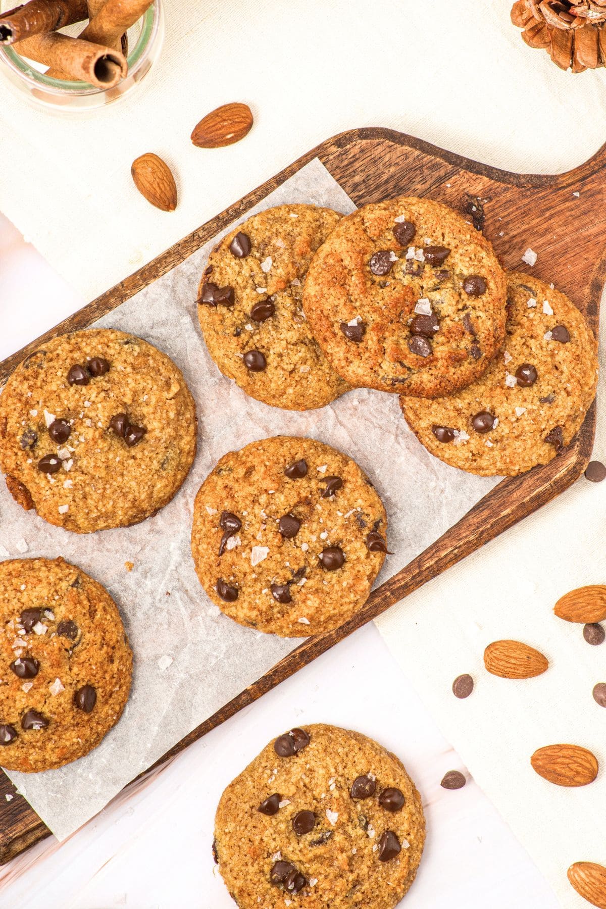 Pumpkin Almond Flour Cookies (Gluten-Free, Dairy-Free) Top down view of pumpkin almond flour cookies on parchment-lined wooden board.
