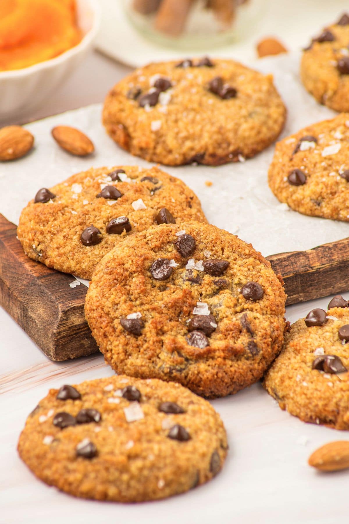 Almond Flour Pumpkin Cookies (Gluten-Free, Dairy-Free) Almond flour pumpkin cookies with chocolate chips on wooden board.