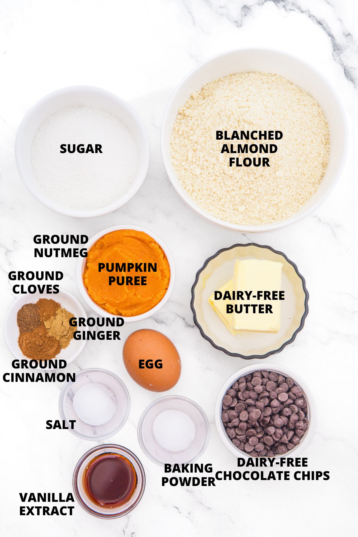 Almond Flour Pumpkin Cookies Recipe (Gluten-Free, Dairy-Free) Ingredients for almond flour pumpkin cookies laid out on marble board.