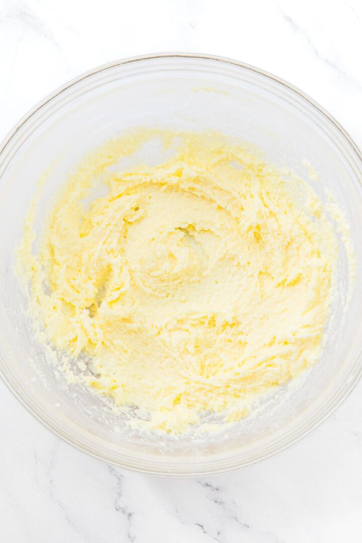 Creamed butter and sugar in glass bowl.