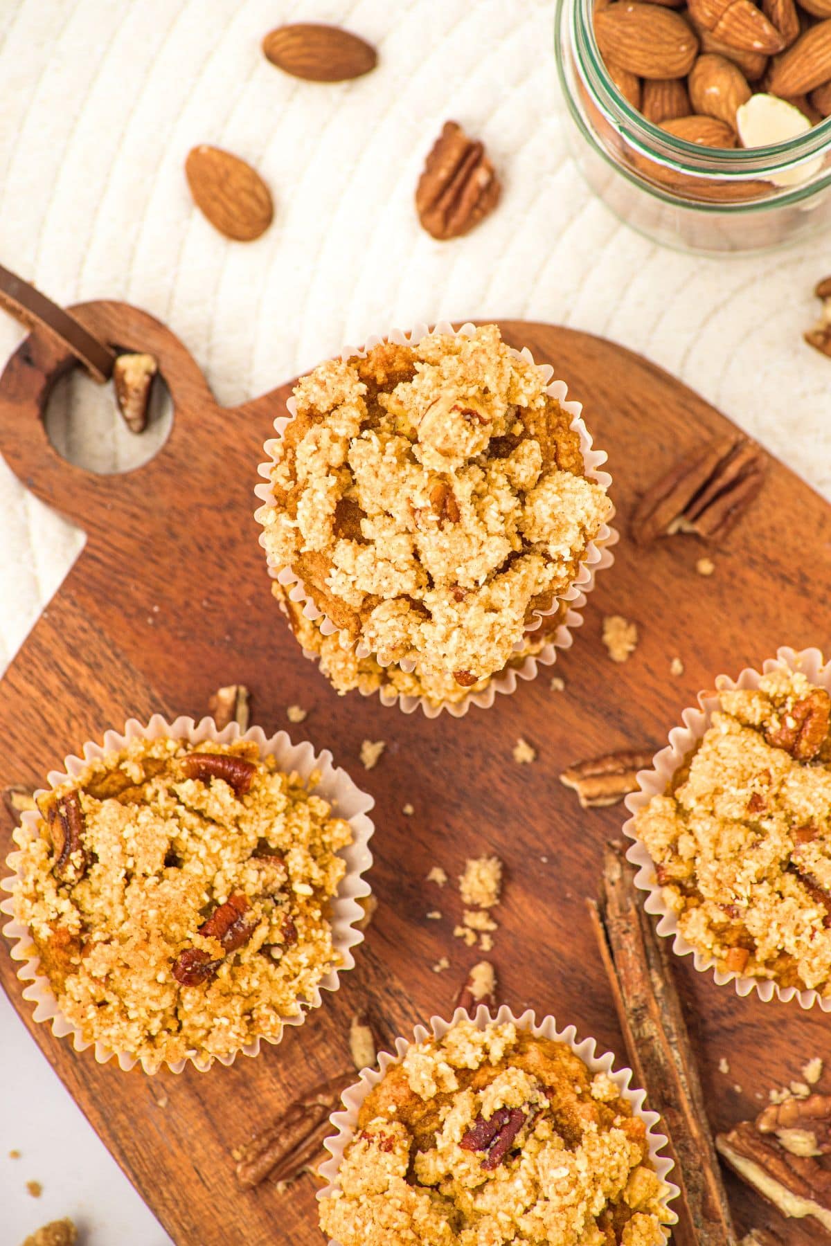 Top down view of pumpkin almond flour muffins on wooden board.