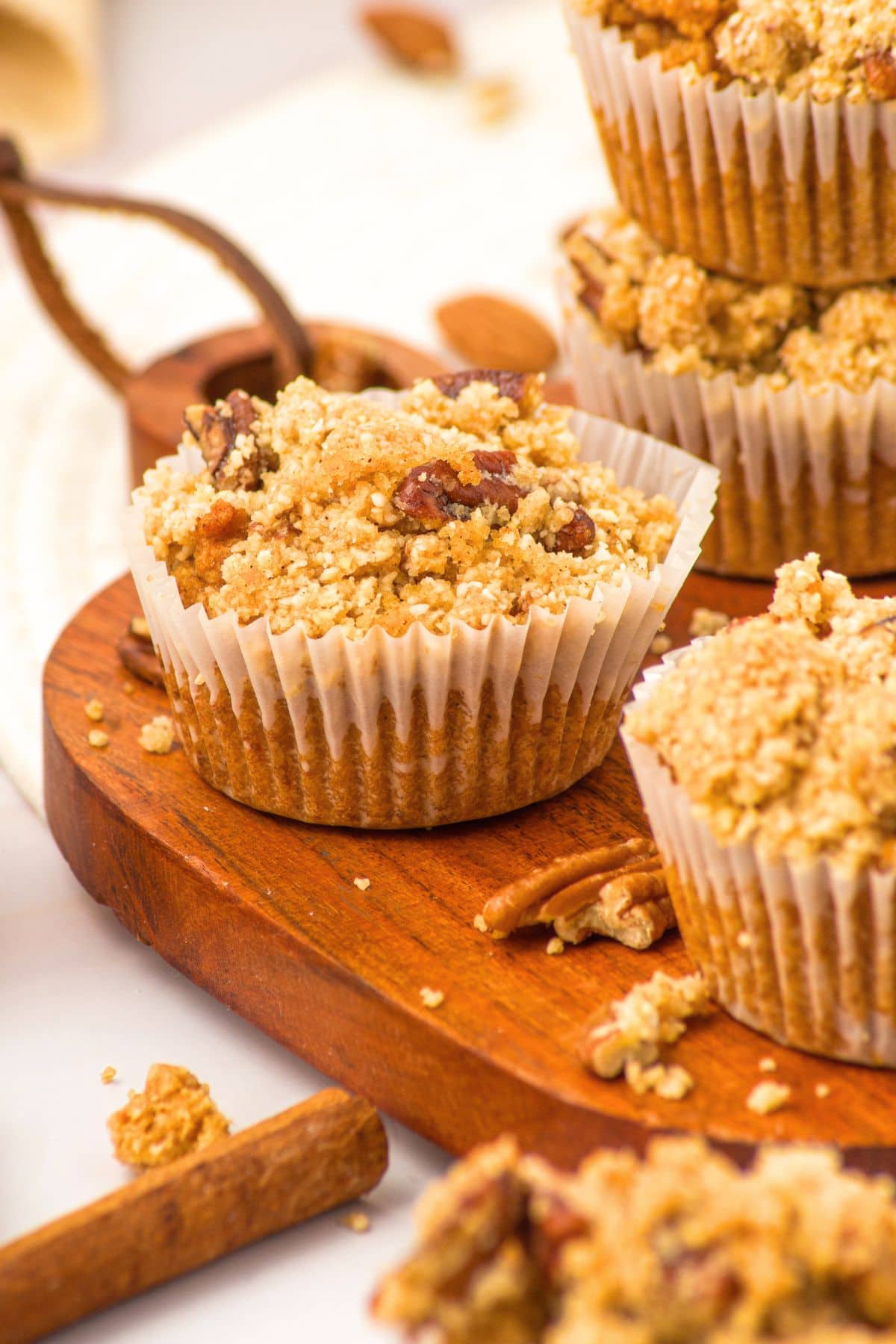 Almond flour pumpkin muffins on wooden board.