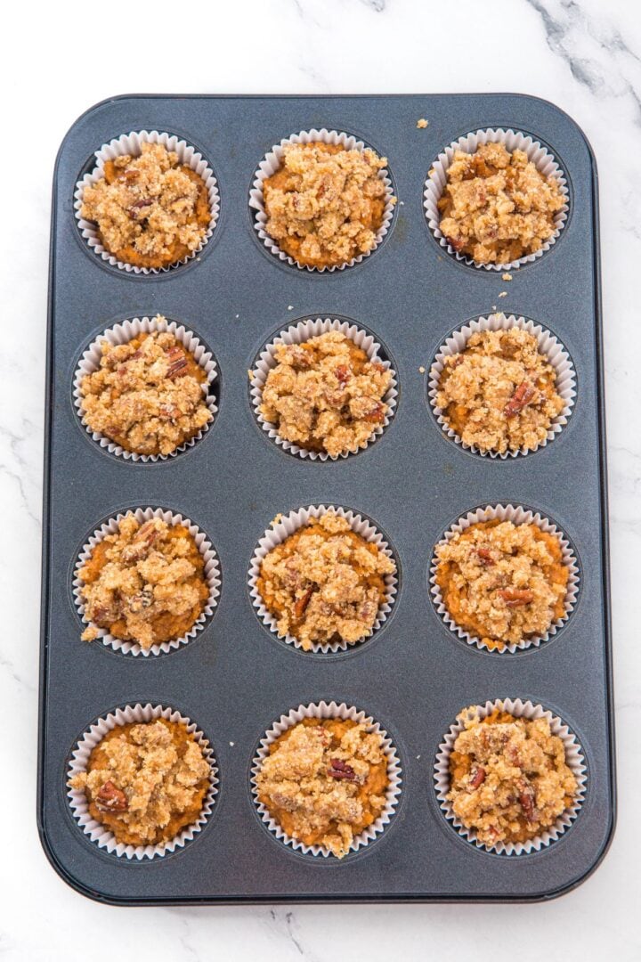 Pumpkin muffin batter topped with streusel.