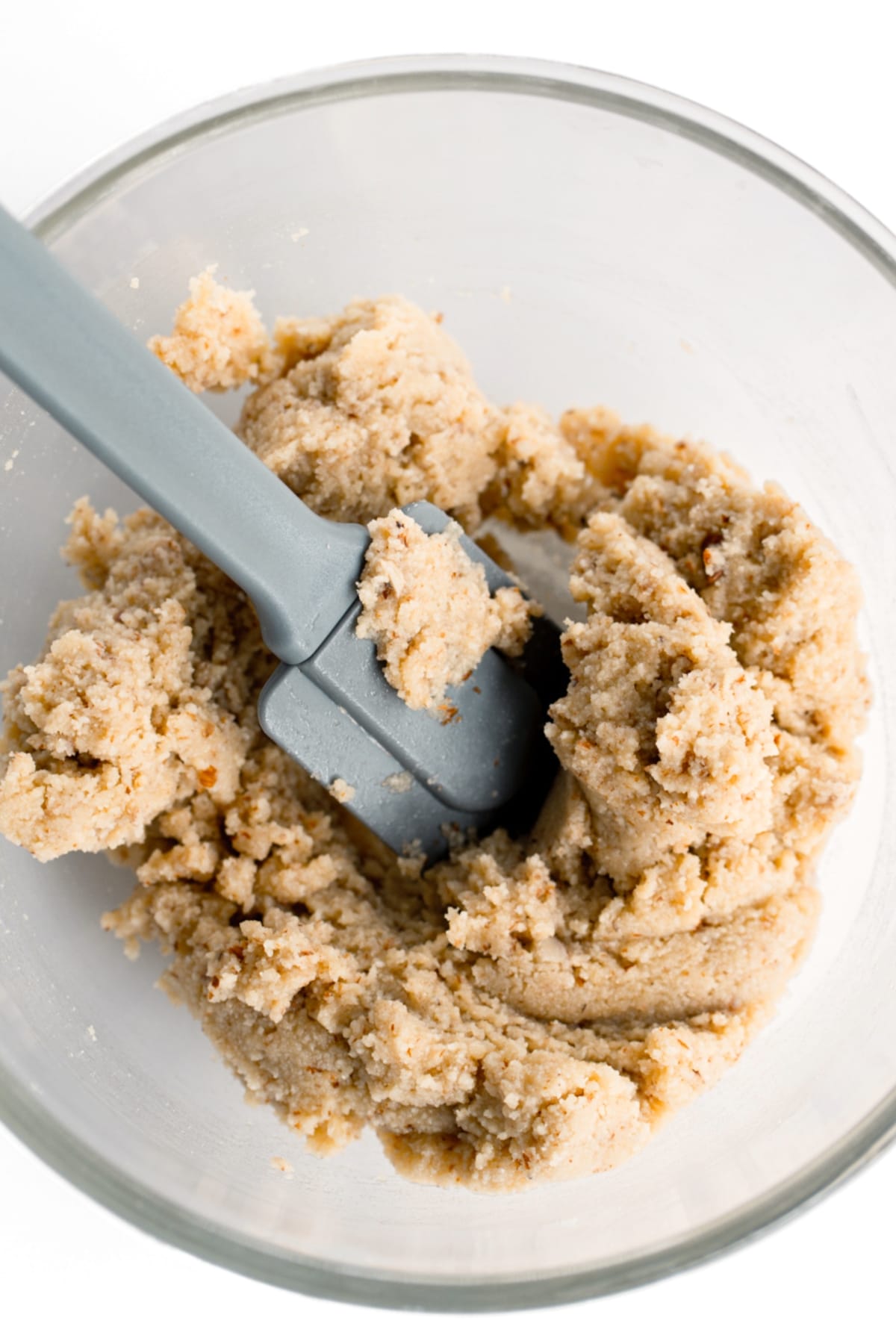 Mixing almond flour cookie dough with spatula.