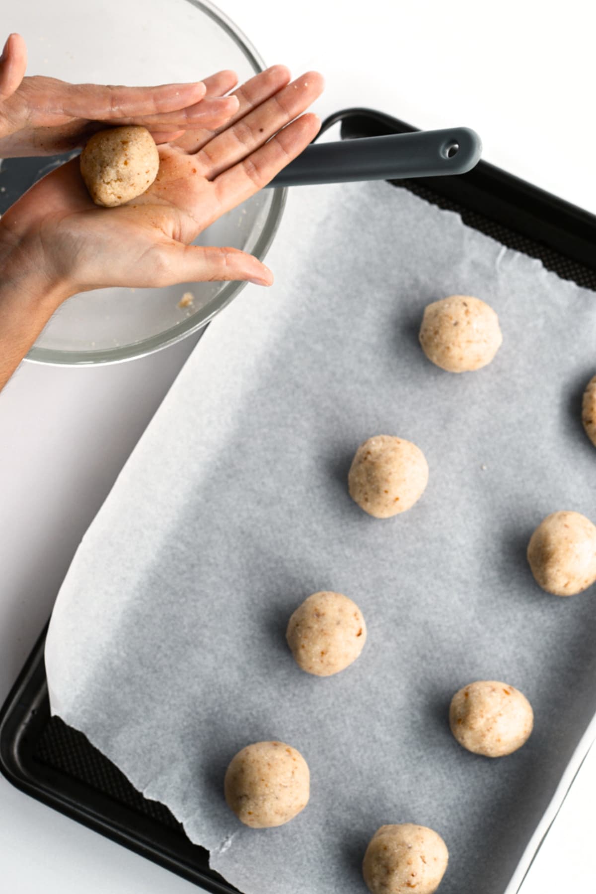 Rolling almond flour cookie dough into balls.