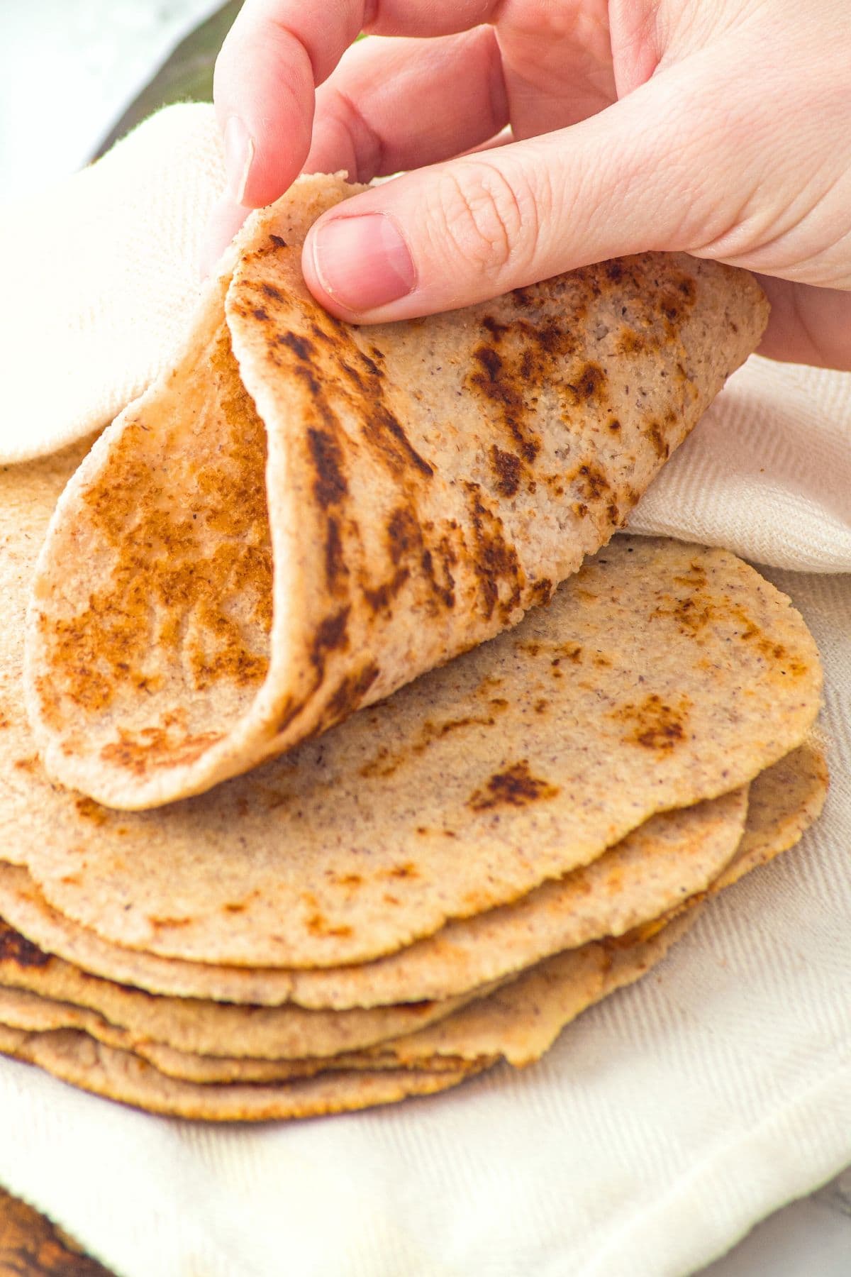 Hand folding tortilla in half
