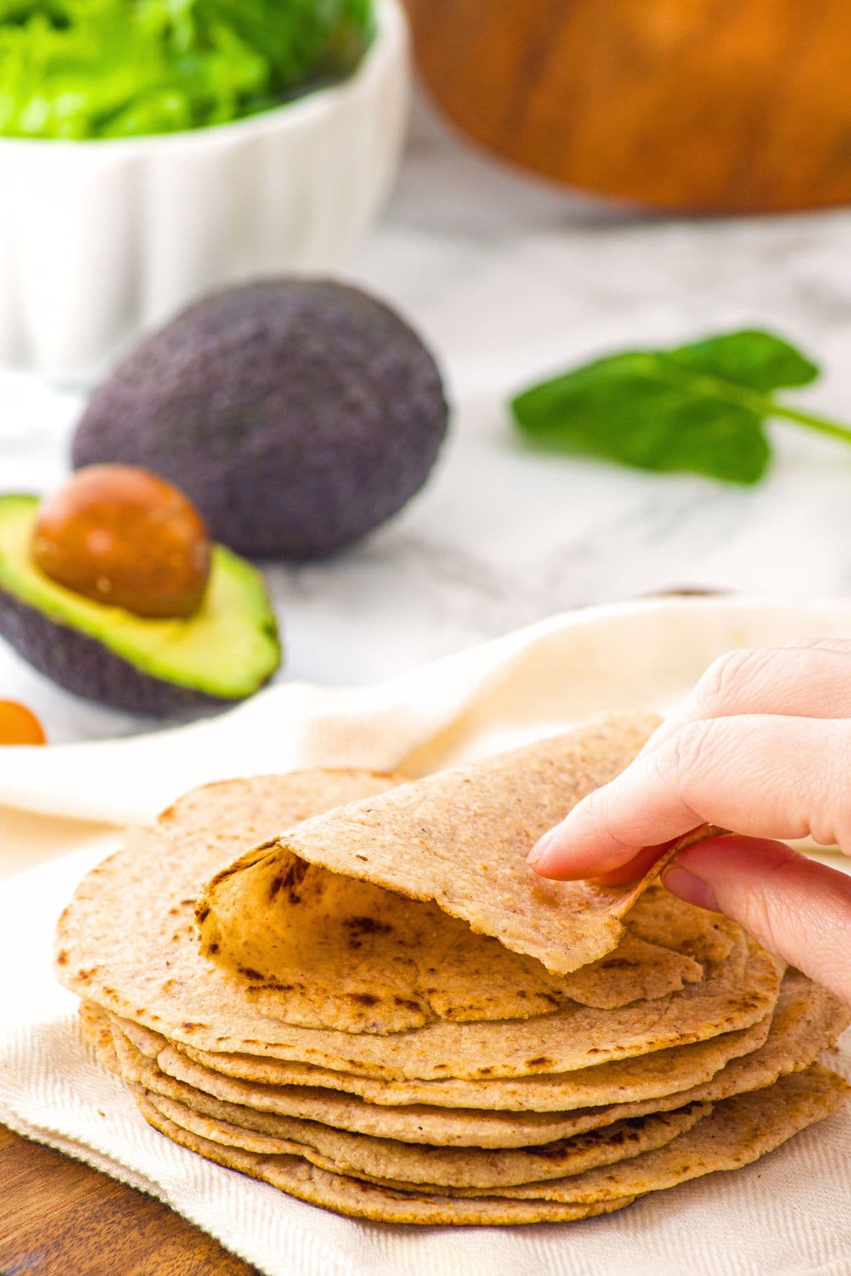 Hand folding a tortilla into half