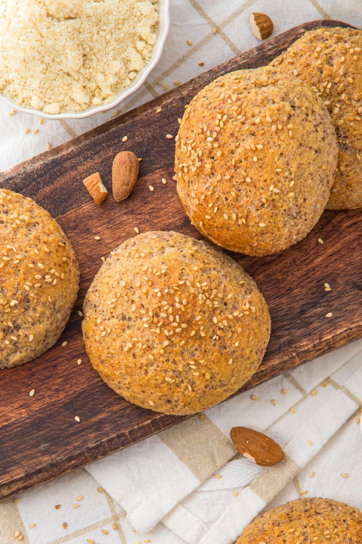 Top down view of almond flour yeast rolls on wooden board
