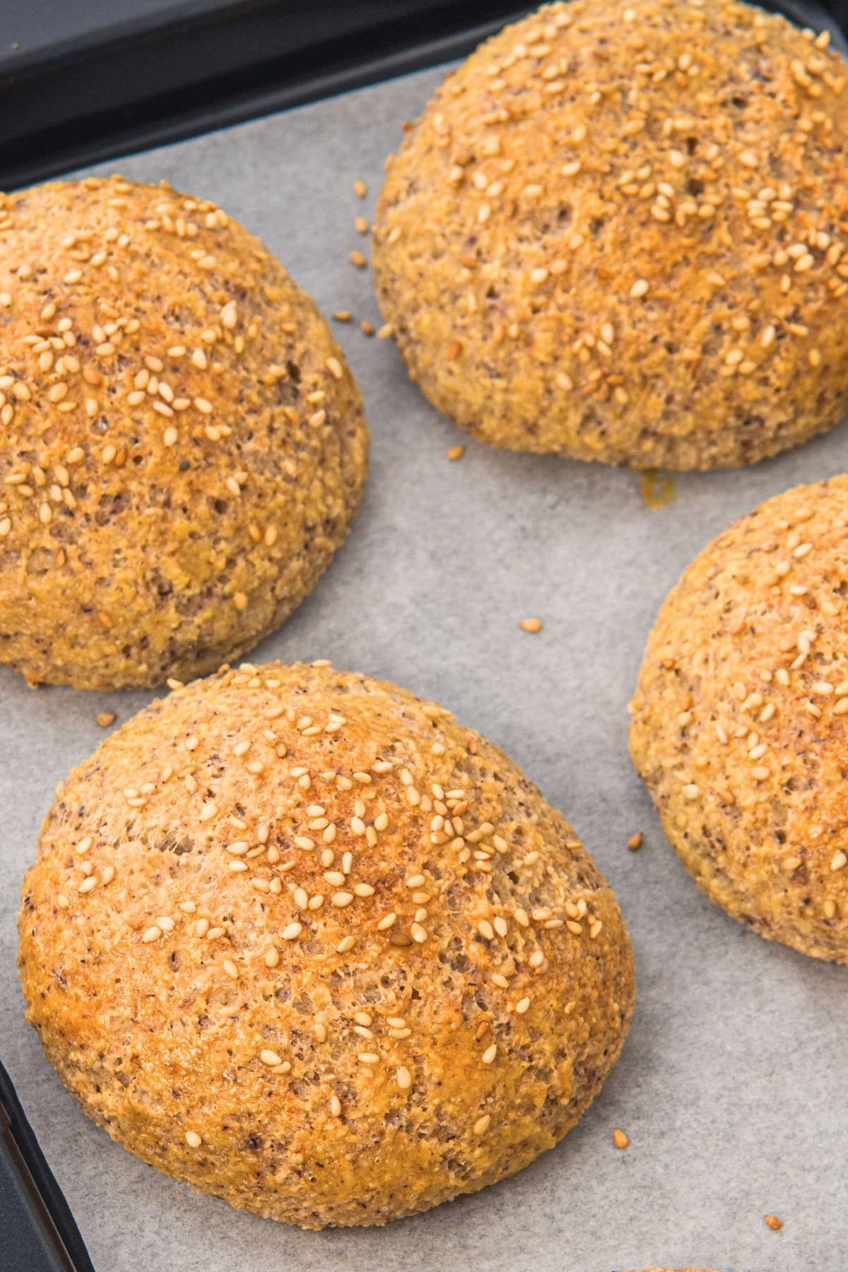 Freshly baked low carb almond flour rolls on parchment paper