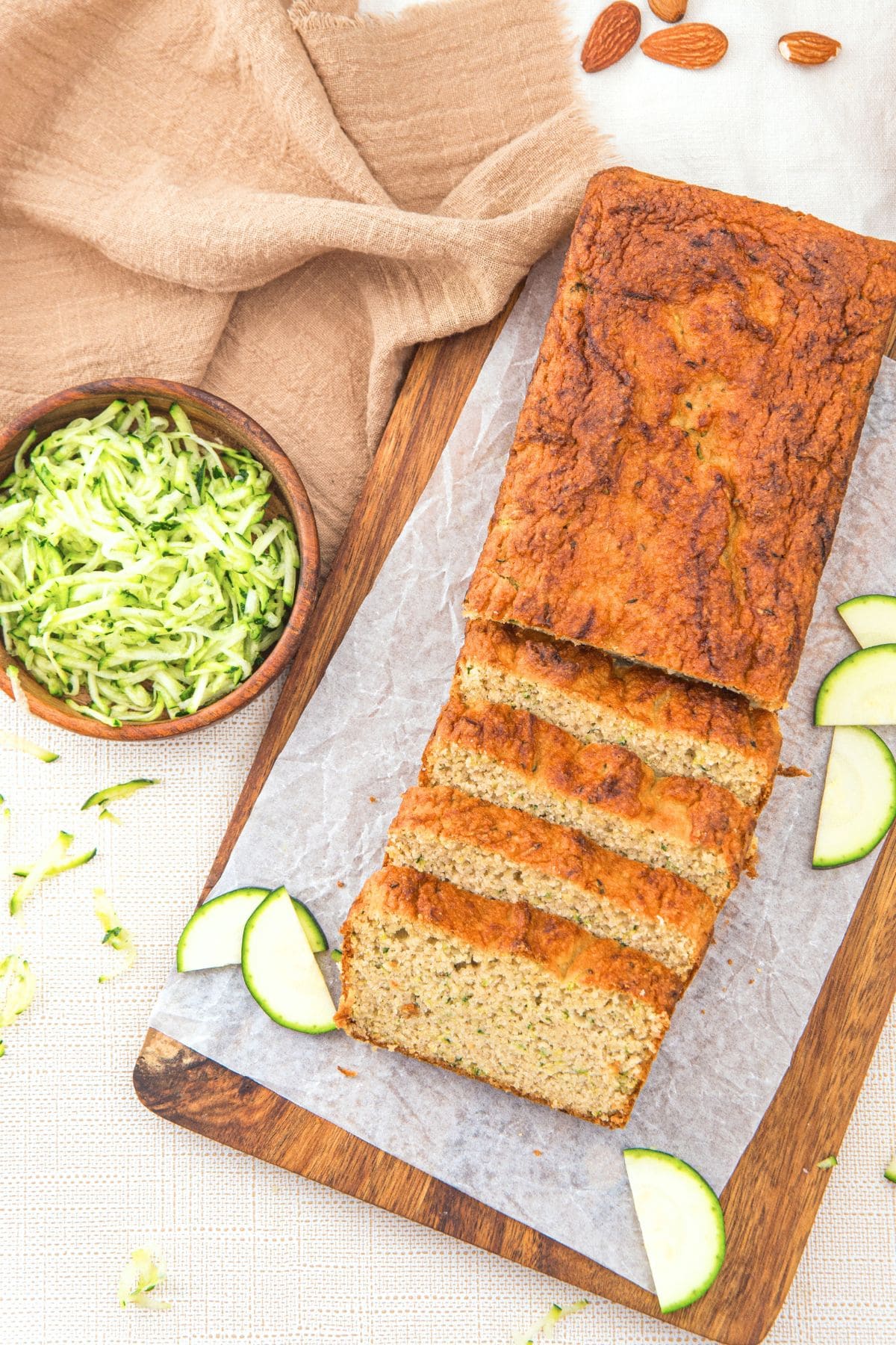 Sliced almond flour zucchini loaf on parchment-lined board