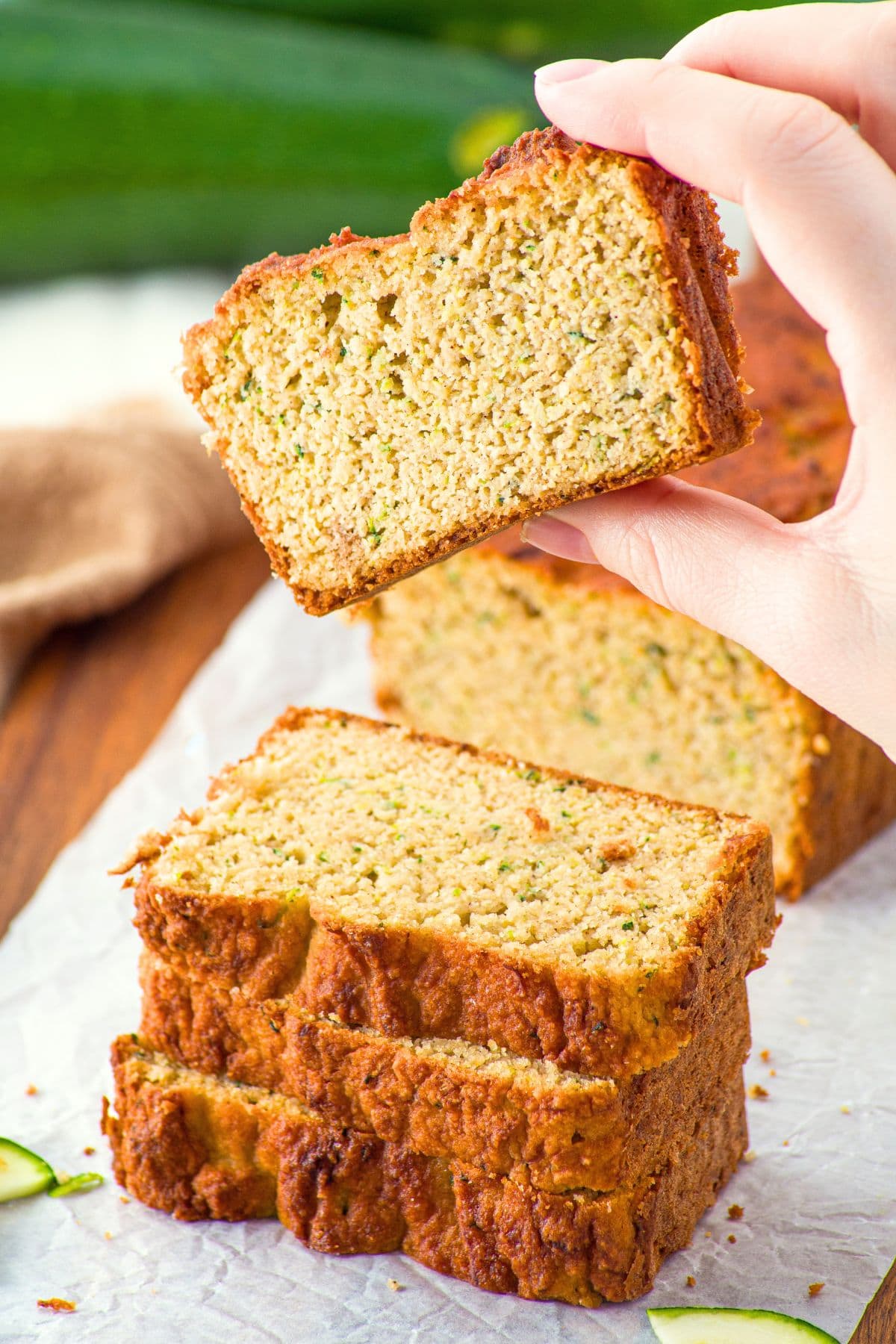 Holding up a slice of zucchini bread
