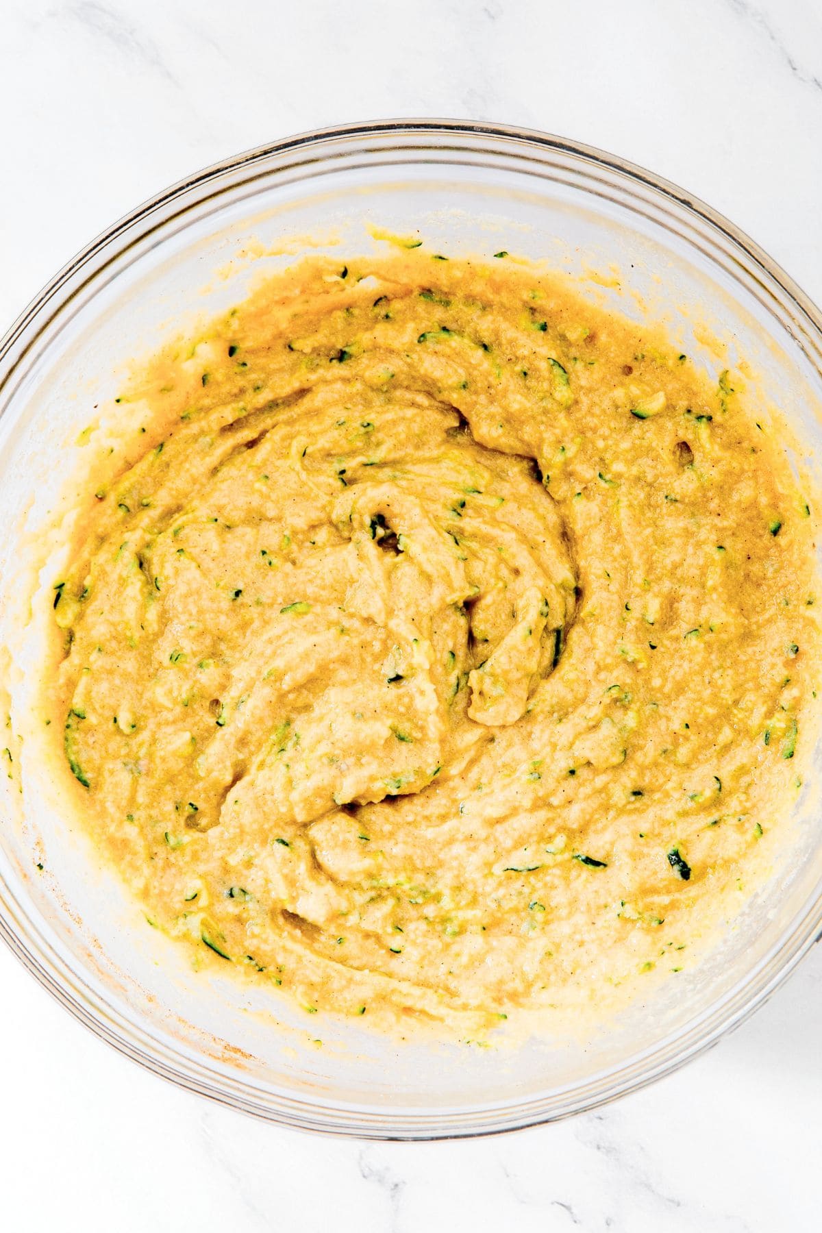 Zucchini bread batter in glass bowl