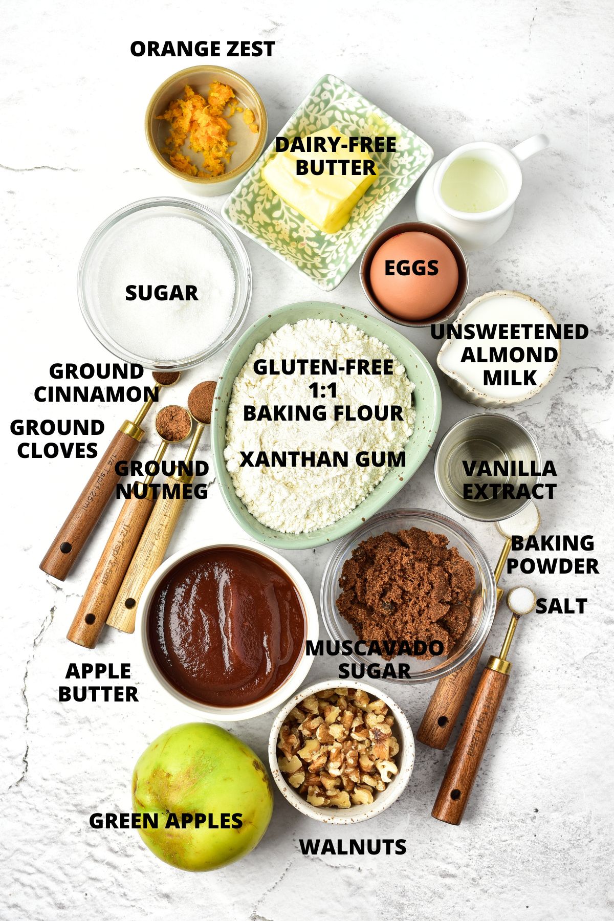 Ingredients for apple butter bread recipe laid out on marble board.