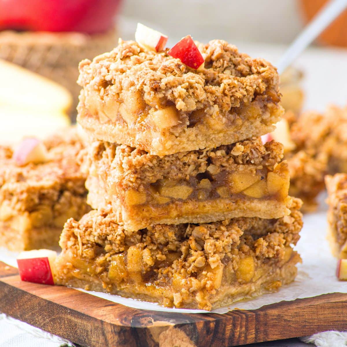 A stack of apple oatmeal bars on wooden board