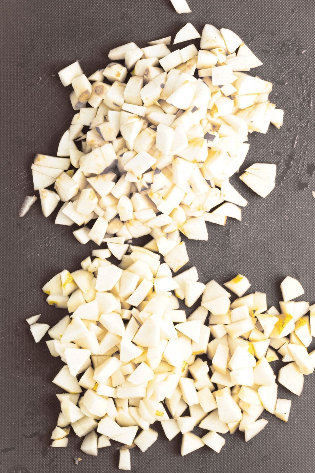 Diced apples and pears on chopping board.