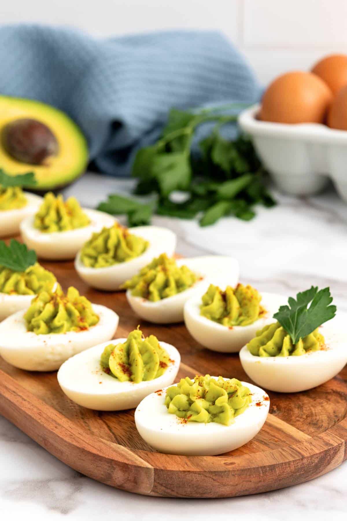 GF avocado deviled eggs sprinkled with ground paprika.