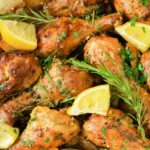 Baked chicken legs topped with rosemary and lemon