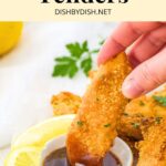 Dipping a chicken tender into a bowl of BBQ sauce