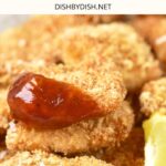 Up close view of nuggets dipped in ketchup