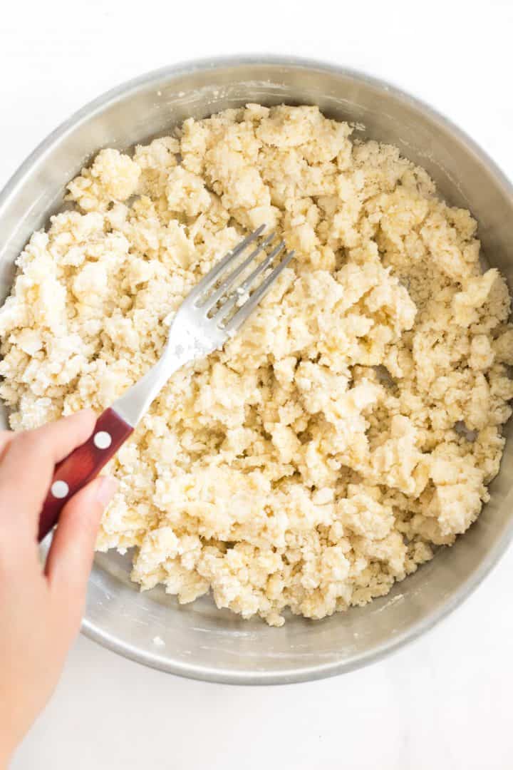 Mixing pie dough ingredients together in metal pan