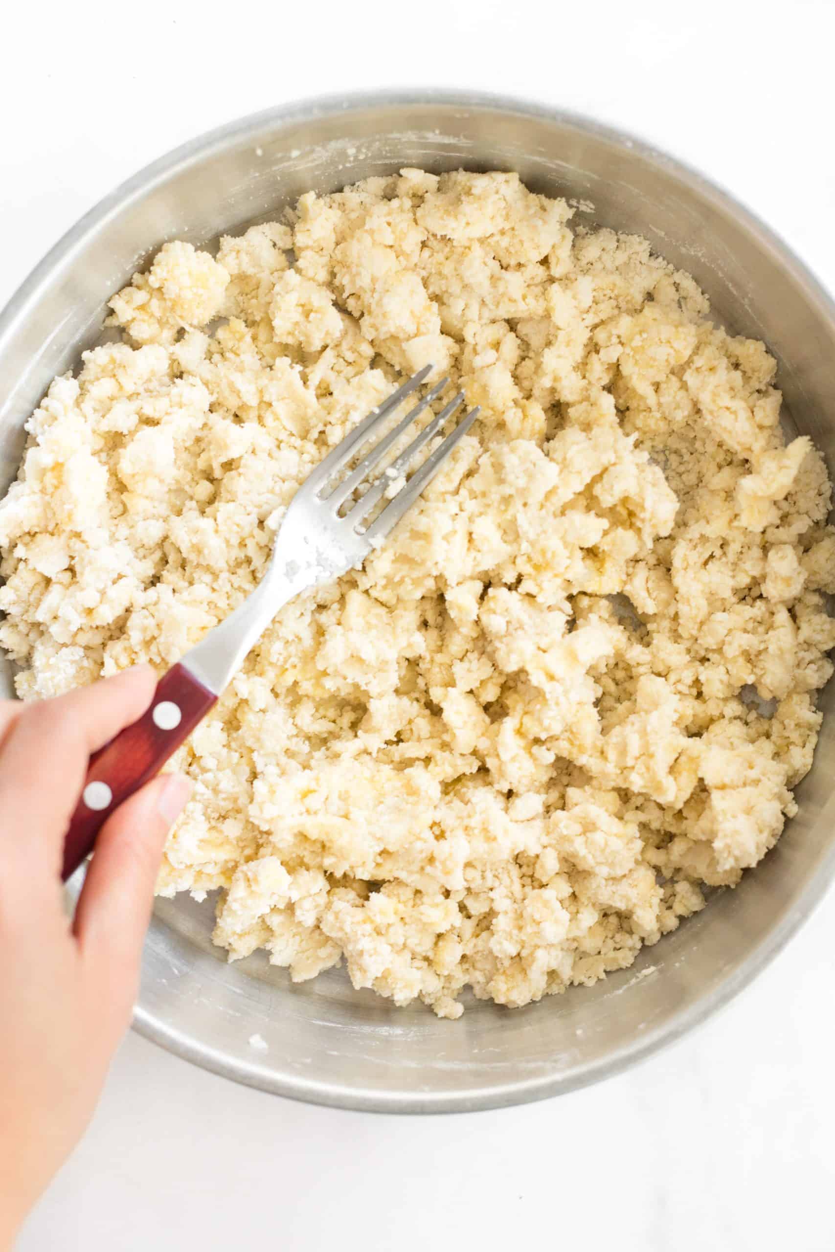 Using a fork to mix up the flour mixture.
