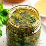 Up close view of a jar of basil chimichurri sauce