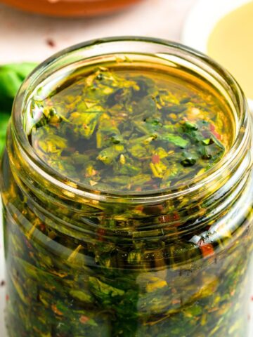 Up close view of a jar of basil chimichurri sauce