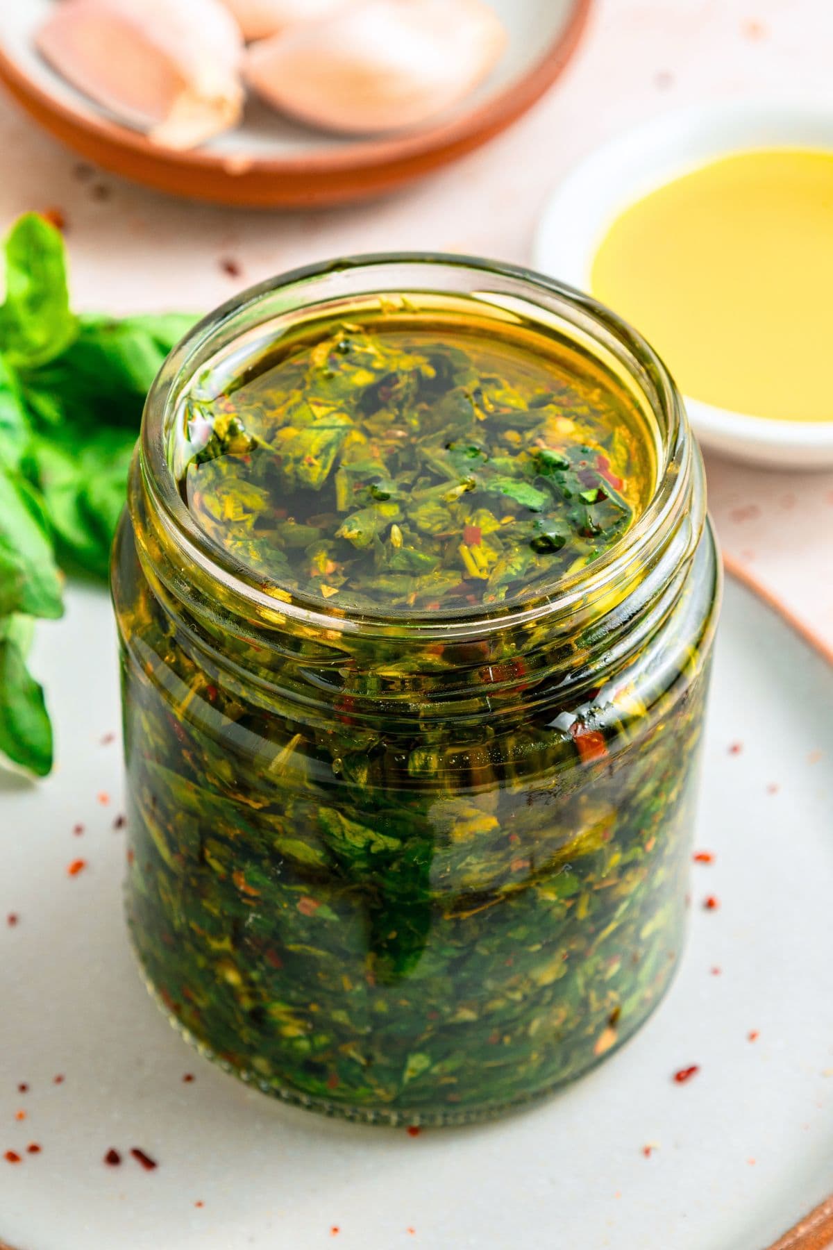 Up close view of a jar of basil chimichurri sauce