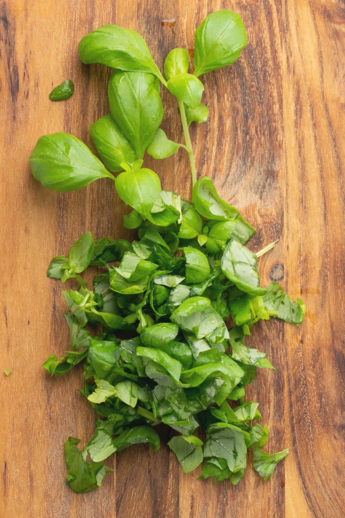 Chopped fresh basil on wooden board