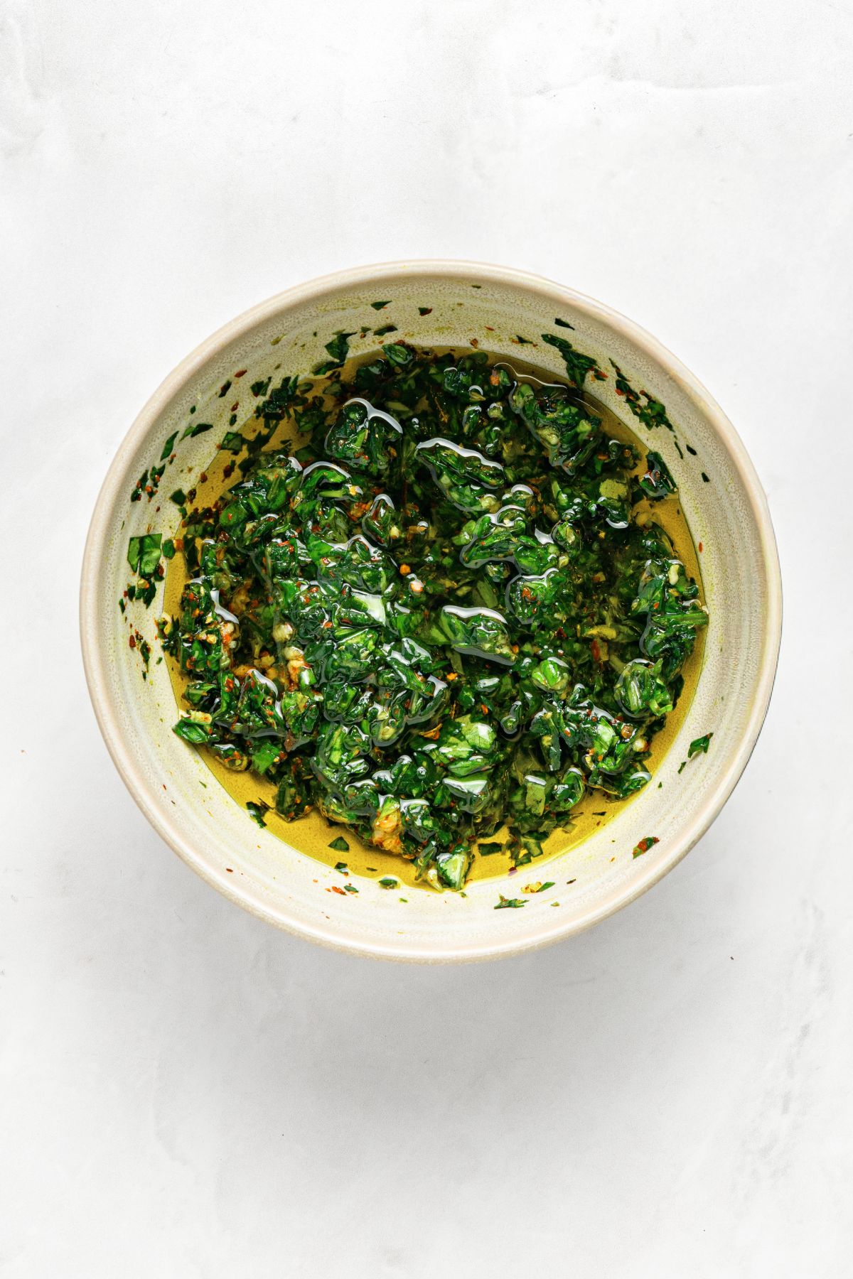 A bowl with fresh basil chimichurri