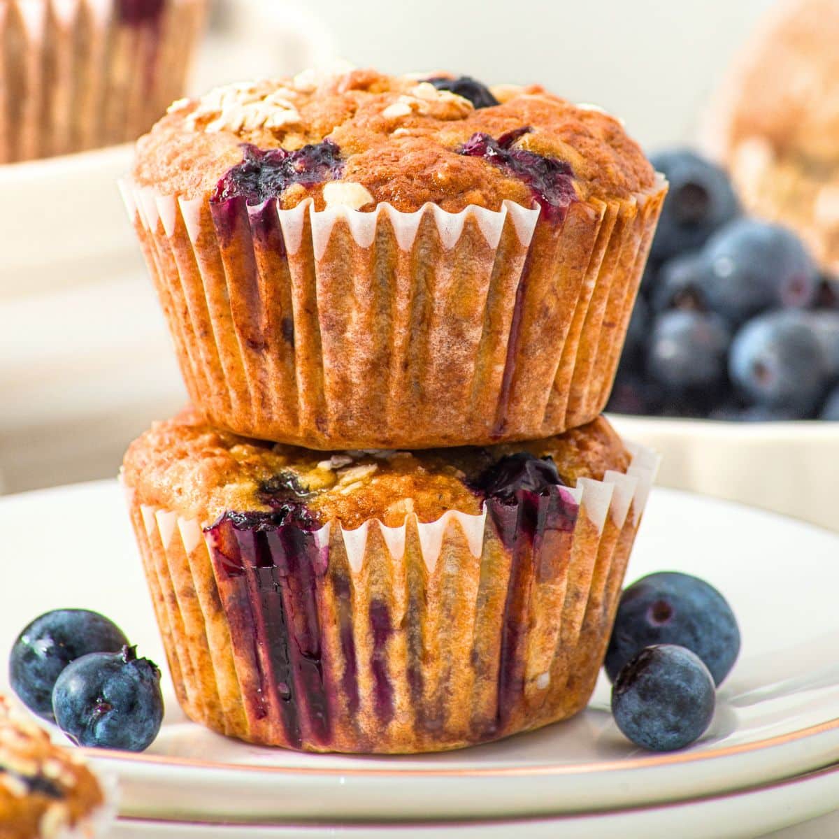 A stack of blueberry banana oatmeal muffins on plate