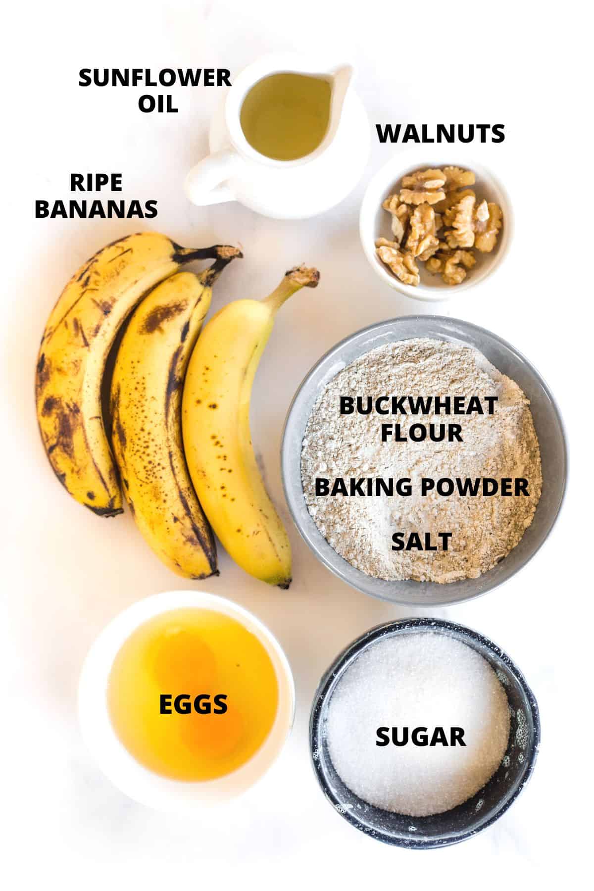 Ingredients required for banana buckwheat bread laid out on marble board.