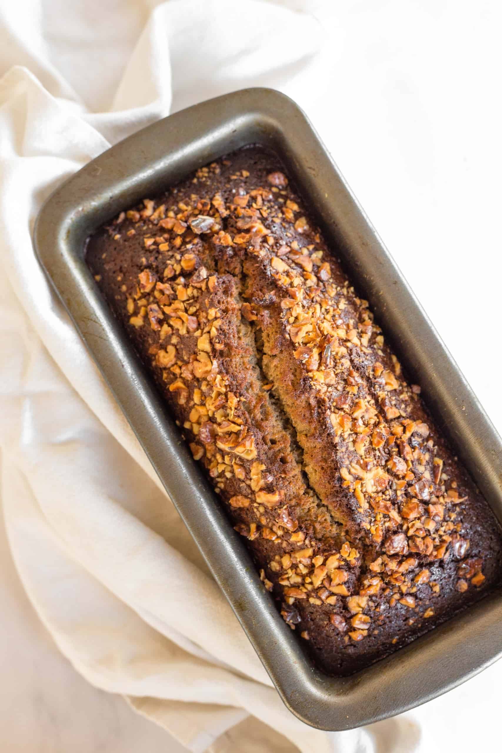 Freshly baked loaf of banana bread in metal pan.