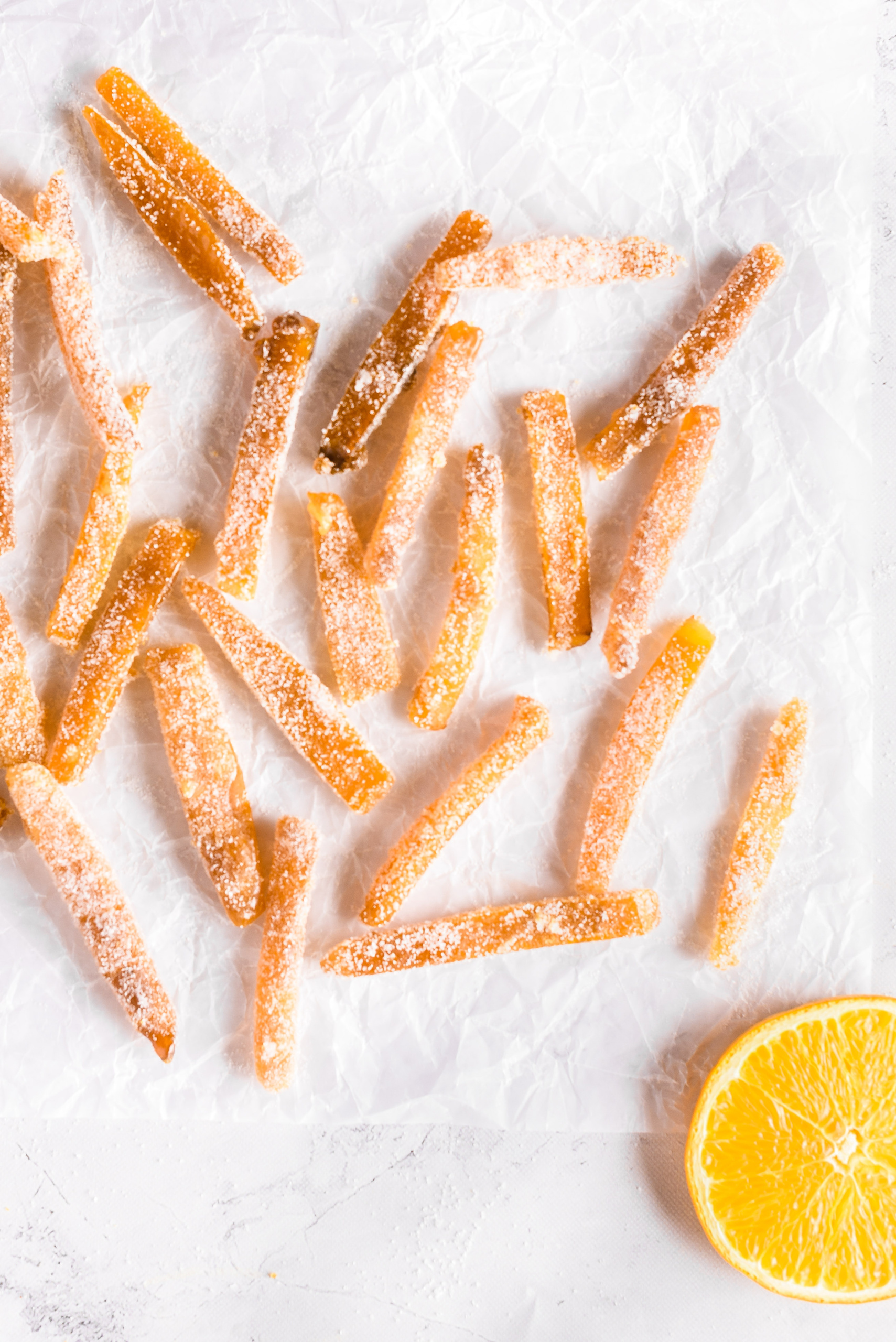Candied orange peels on parchment paper.