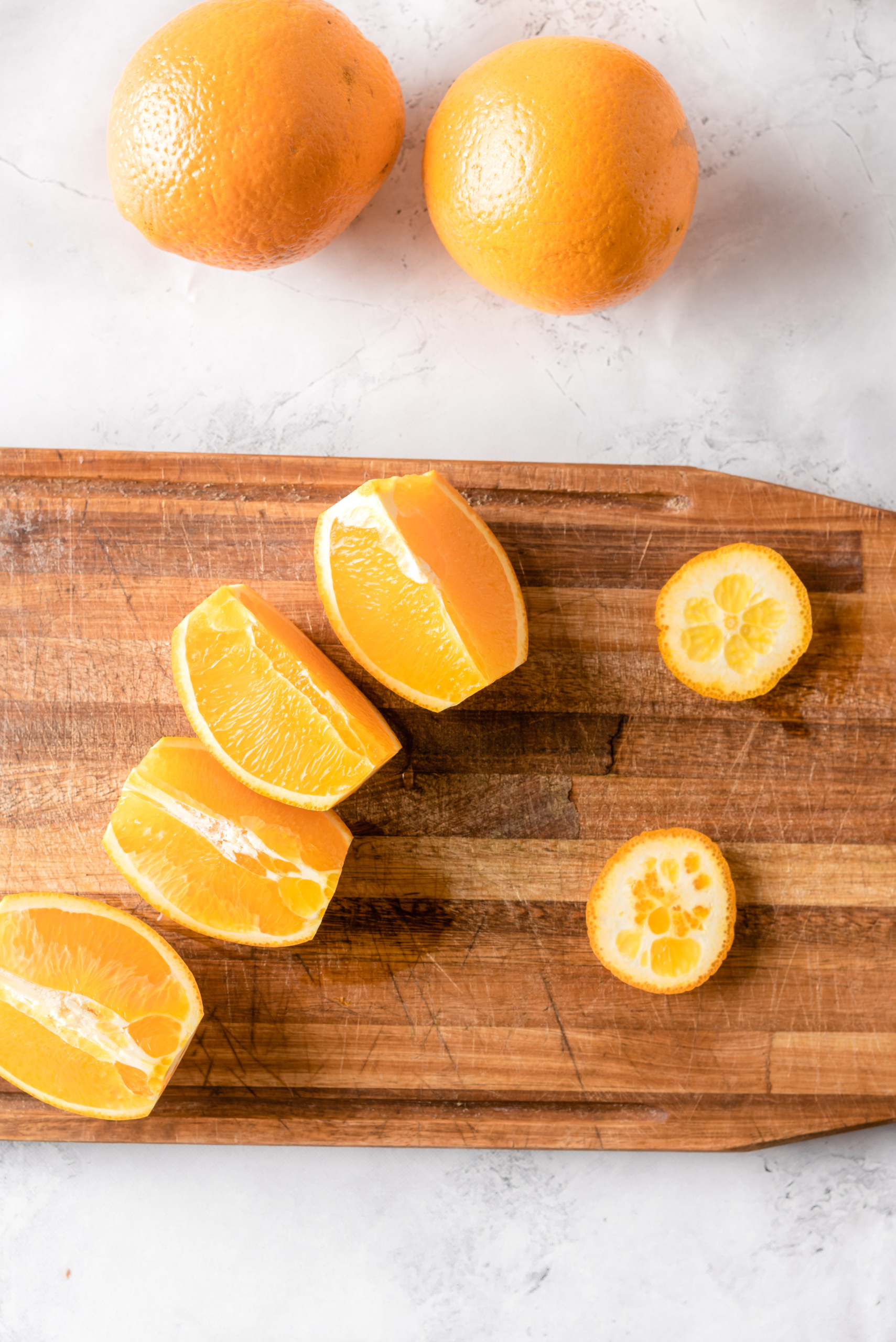 Fresh cut oranges on a wooden board.