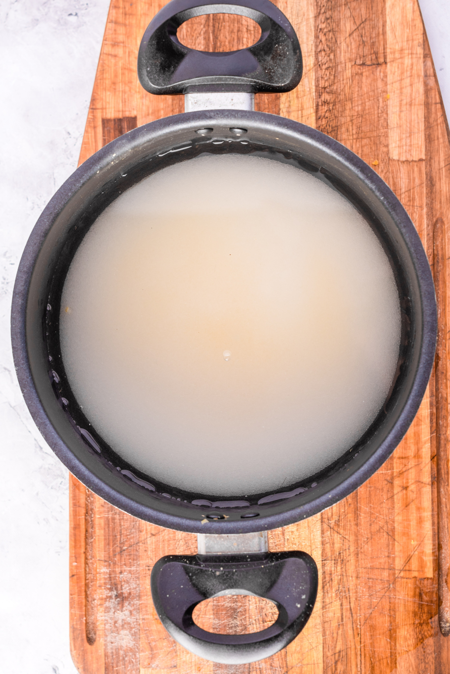 Sugar water mixture about to be boiled in a large pot.